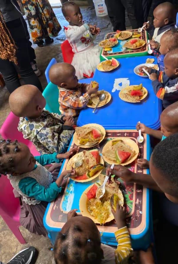 Children enjoying a shared meal during the Jehovah Jireh visit